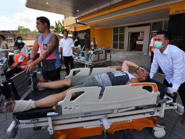 An injured foreign tourist receives medical attention at a makeshift unit set up outside the Moh. Ruslan hospital in Mataram. Picture: AFP