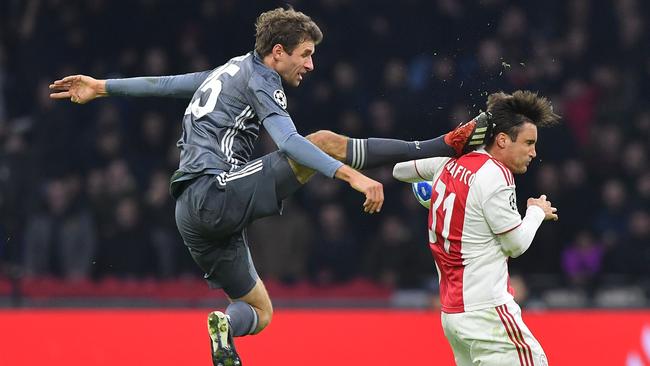 Bayern Munich’s Thomas Mueller kicks the back of Ajax defender Nicolas Tagliafico in Amsterdam. Picture: AFP