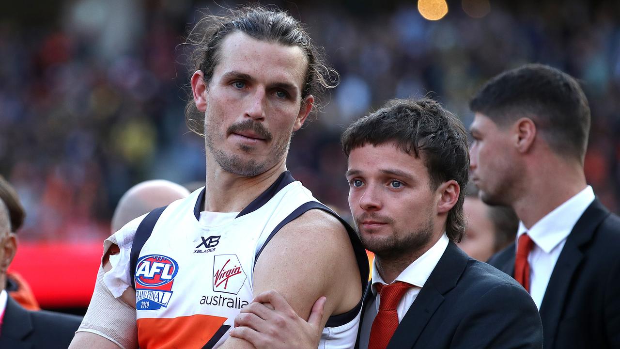 GWS Giants captain Phil Davis dejected consoled by teammate Dylan Buckley after losing to Richmond in the 2019 AFL Grand Final at the MCG. Picture. Phil Hillyard