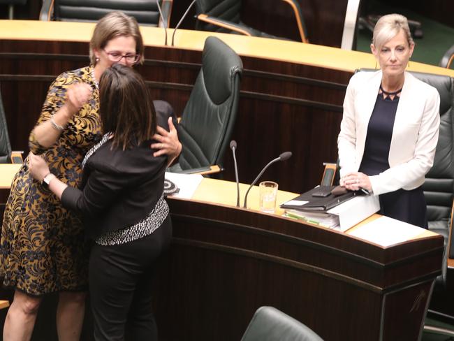 Greens leader Cassy O'Connor and Labor's Ella Haddad celebrate in State Parliament as Attorney General Elise Archer stands after the passage new legislation about birth certificates on Tuesday, November 20, 2018.