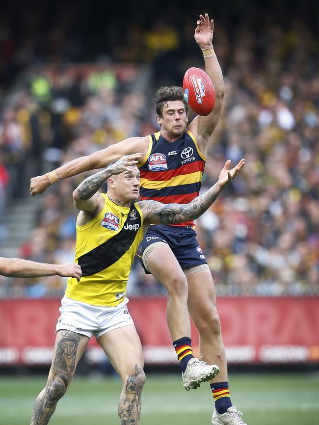 Richmond’s Dustin Martin goes up for the ball with Adelaide’s Kyle Hartigan in last year’s grand final. Picture: David Caird