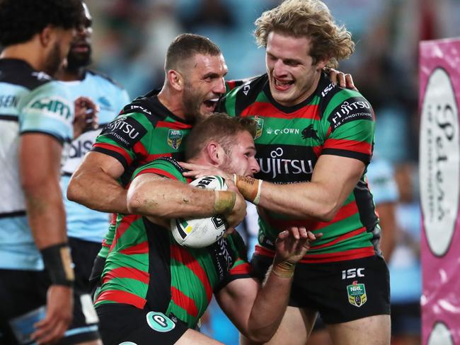 SYDNEY, AUSTRALIA - JUNE 01:  Thomas Burgess of the Rabbitohs celebrates with team mates after scoring a try during the round 13 NRL match between the South Sydney Rabbitohs and the Cronulla Sharks at ANZ Stadium on June 1, 2018 in Sydney, Australia.  (Photo by Matt King/Getty Images)