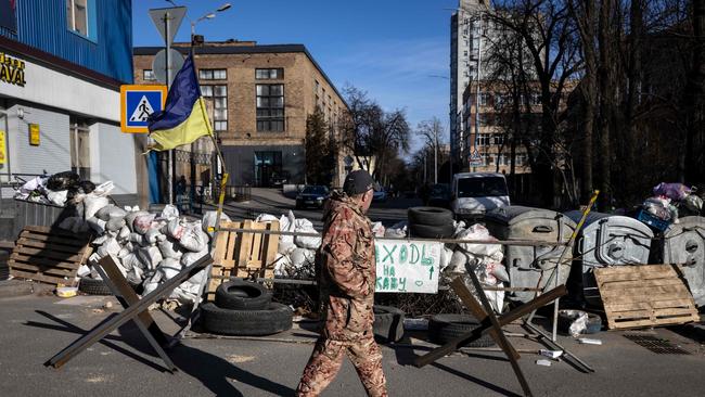 A flag of Ukraine is displayed at a military check point in the center of Kyiv. Picture: AFP