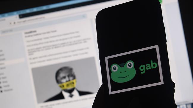 Young Australian men are engaging with banned far-right terrorist groups on Gab new research has found. (Photo by Olivier DOULIERY / AFP)