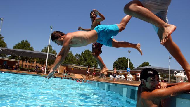 Mates take a plunge during the school holidays. Picture: Brad Hunter