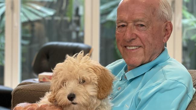 Veteran Port Douglas developer John Morris, 95, with Pebbles, at his new abode in Escape Villas, his latest creation. Mr Morris said it was time for a focus on five star-plus developments. Picture: Bronwyn Farr