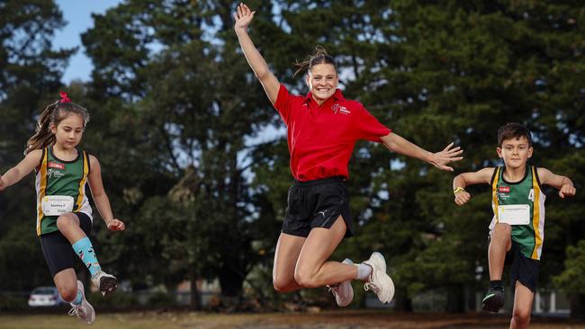 Olympic Gold Medalist Nina Kennedy (C) poses for a photo with Sammy (L) and Jack from Sandringham Little Athletics Club during a media op with Coles and Little Athletics at Sandringham Little Athletics Club in Melbourne on October 14th, 2024. Picture: Martin Keep/Coles