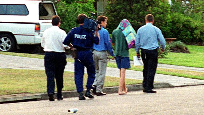 SLD (under a towel) with police after the murder of Courtney Morley-Clarke in 2001.