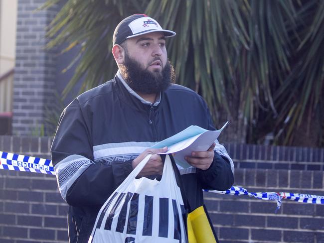 Abraham Derbas leaves Ms Fadlallah’s home with some bags and paperwork. Picture: Liam Mendes