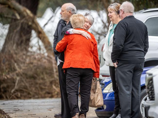 Mourners greet each other outside the memorial service. Picture: Jake Nowakowski