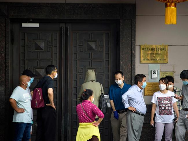 People attempt to talk to someone at the Chinese consulate in Houston. Picture: AFP