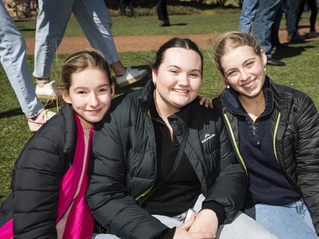 Watching the rugby are (from left) Frankie Barwick, Annie Anderson and Bella Quinn at Grammar Downlands Day at Toowoomba Grammar School, Saturday, August 19, 2023. Picture: Kevin Farmer