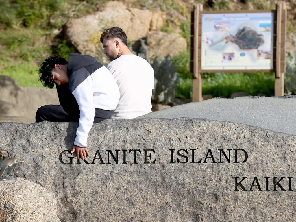 <p>Sahil Habibi brother of missing teen Mehdi Habibi sits on the Granit Island sign after his brother went missing in waters off Granite Island. Picture: Kelly Barnes</p>