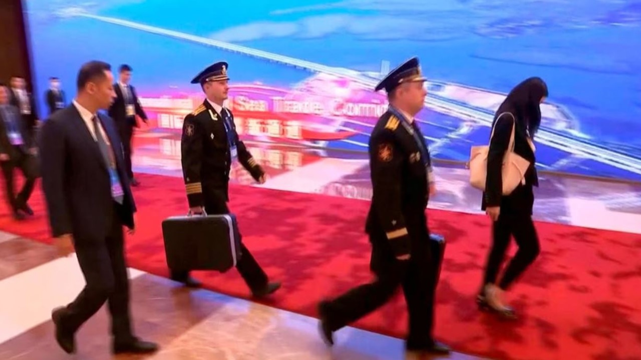 Footage shows Russian President Vladimir Putin accompanied by officers with a briefcase during his trip to China.