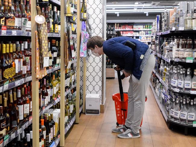 A man shops for alcohol in Moscow. Stuck in cramped flats and struggling with fears of the coronavirus, many Russians are worried about the return of an old demon – alcoholism. Picture: AFP