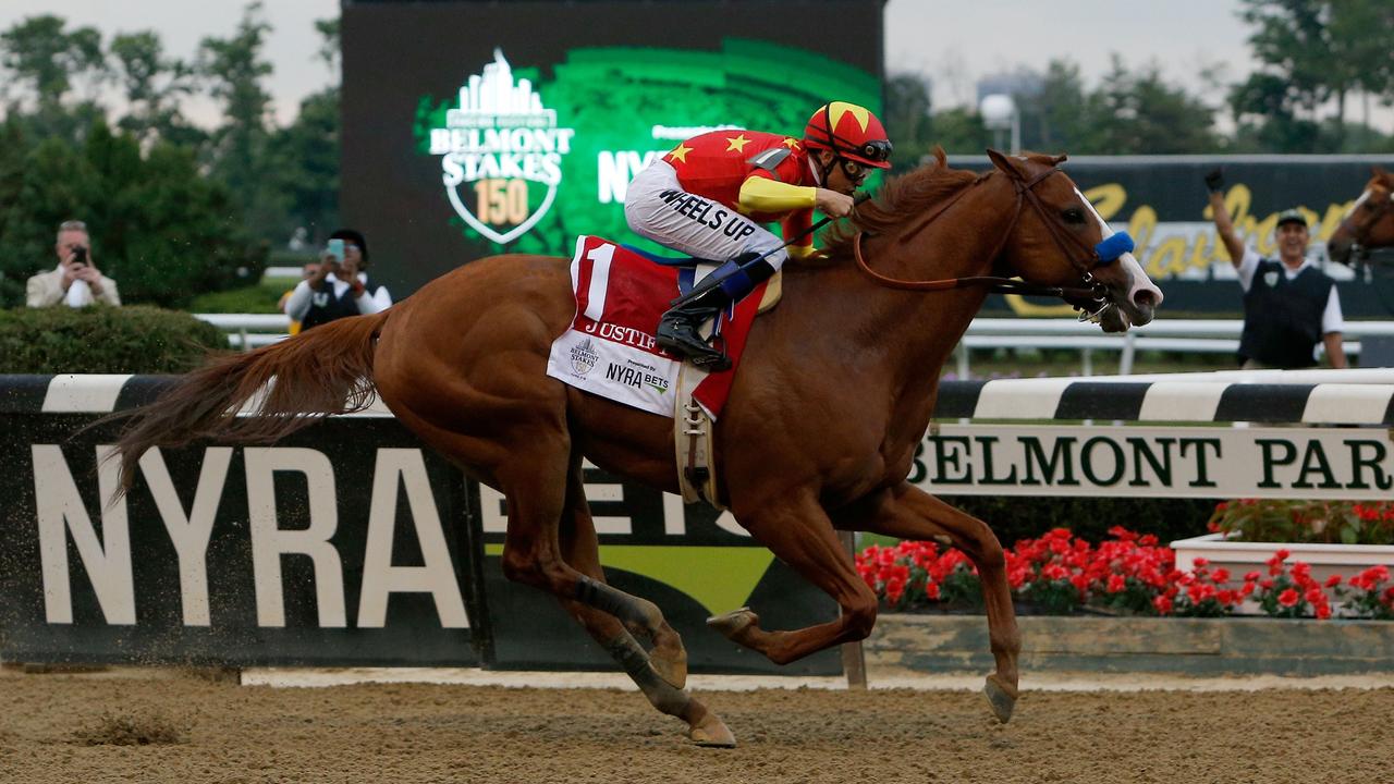 Justify #1, ridden by jockey Mike Smith leads the field to the finish line to win the 150th running of the Belmont Stakes at Belmont Park on June 9, 2018 in Elmont, New York. Justify becomes the thirteenth Triple Crown winner and the first since American Pharoah in 2015. Michael Reaves/Getty Images/AFP