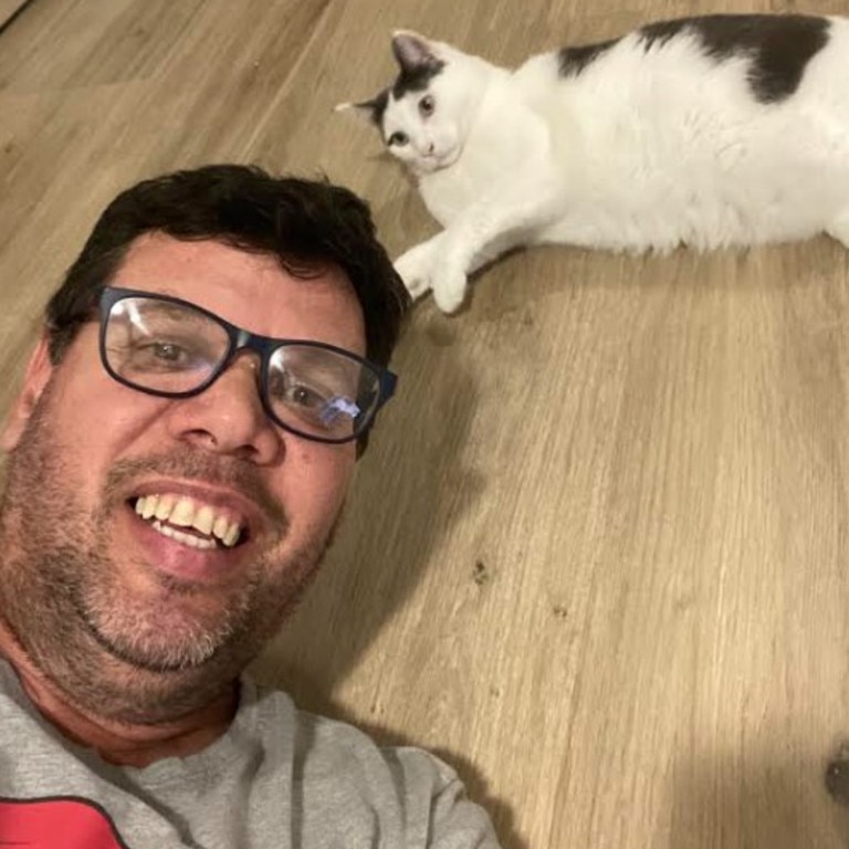 Mr Gray and his rescue cat crystal. Picture: Supplied