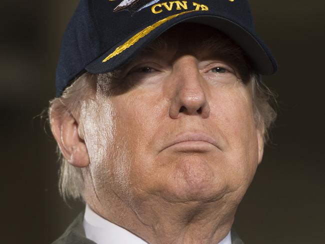 (FILES) This file photo taken on March 2, 2017 shows US President Donald Trump  aboard the pre-commissioned USS Gerald R. Ford aircraft carrier in Newport News, Virginia, March 2, 2017. US President Donald Trump is to sign a revised executive order on immigration March 6, 2017, after his first version was blocked by federal courts, senior aide Kellyanne Conway said. Conway told Fox News that the order would take effect on March 16. The first version temporarily closed US borders to all refugees and citizens from seven mainly Muslim countries.  / AFP PHOTO / SAUL LOEB