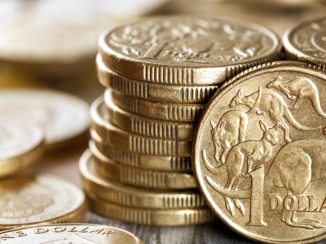 Stacks of Australian one dollar coins.  Focus on front coin. Australian cash, money generic