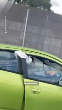 A Melbourne driver holds his door shut with a towel