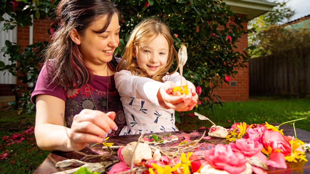 Monica Shepherd and daughter Eva have some fun with homemade playdough in their backyard. Picture: Mark Stewart