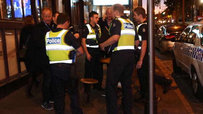 Police speak to people at the scene last night. Picture: David Crosling