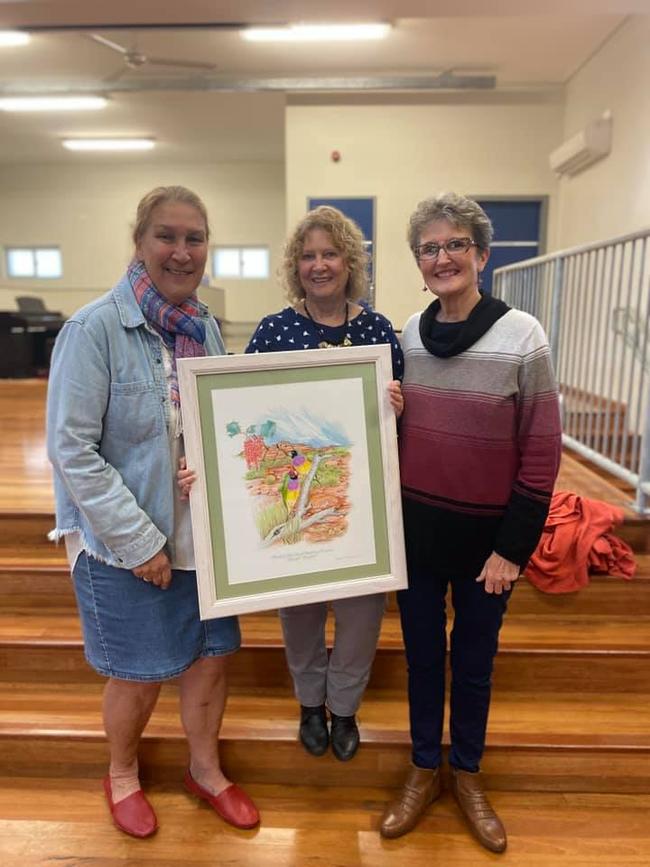 Gillwinga Public School teacher Maree Davis (centre) is presented with her retirement gift by former colleagues Debbie Brookes and Shauna Baker.