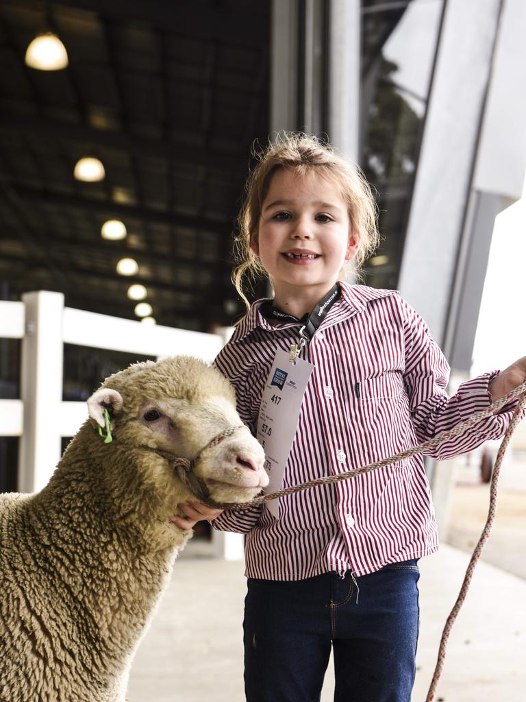 Raiven Cole from Bairnsdale, with a Poll Dorset lamb at the Royal Melbourne Show. Photo: Dannika Bonser