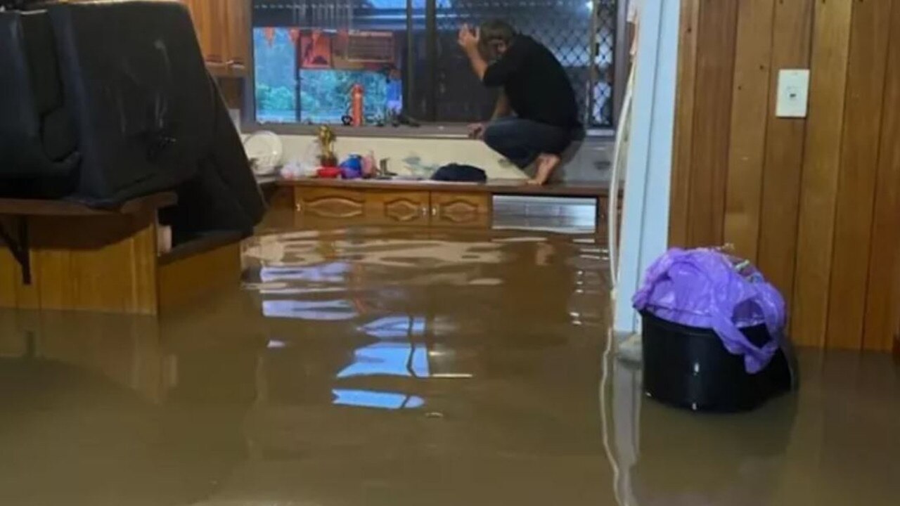 The inside of the family’s home with floodwaters lapping against the top of the benchtops. Photo: GoFundMe