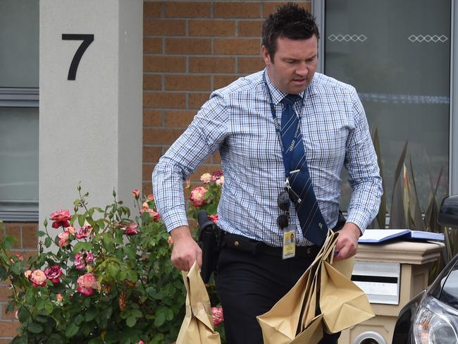 A police officer removes evidence from the home. Picture: Nicole Garmston