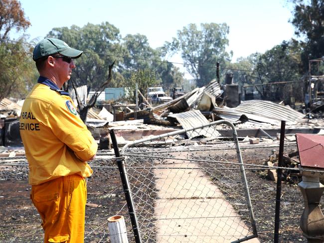 RFS member Paul Crerar inspects one of the houses levelled by the Sir Ivan bushfire. Picture: Peter Lorimer.