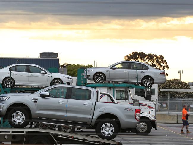 A truckload of Ford Falcons prepares to leave Broadmeadows on the final day of production, alongside a Thailand-made Ford Ranger ute that has been Ford’s top seller in Australia since 2012. Picture: David Crosling