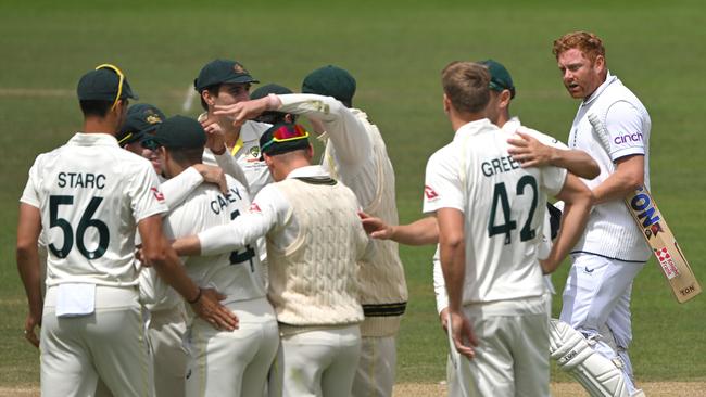 England batsman Jonny Bairstow looks on as Australia fielders celebrate after being given run out.