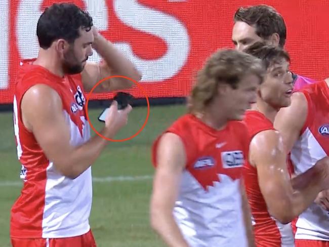 Paddy McCartin can be seen using his phone in the second quarter of Friday night's game against Geelong.