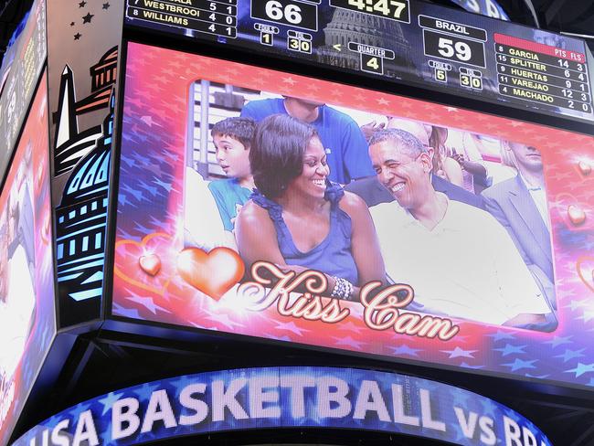 President Barack Obama laughs with first lady Michelle Obama as they appear on the ‘Kiss Cam’ as the US Senior Men’s National Team and Brazil play during a pre-Olympic exhibition basketball game. Picture: Leslie E. Kossoff-Pool/Getty Images