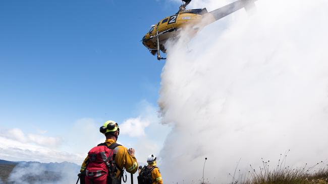 Tasmania Fire Service firefighters with aerial waterbombing at the Gell River fire. Picture: WARREN FREY/TASMANIA FIRE SERVICE