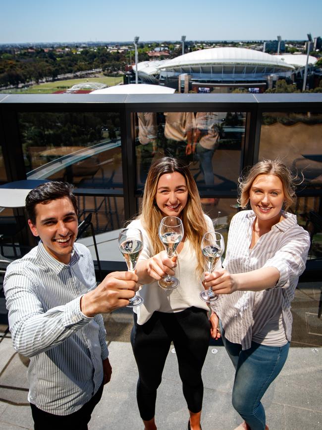 Nick Babadimas, Maddie Murphy and Jessica McHugh celebrate the prospect of hospitality restrictions loosening at SkyCity Eos’s Sol Bar. Picture: Matt Turner