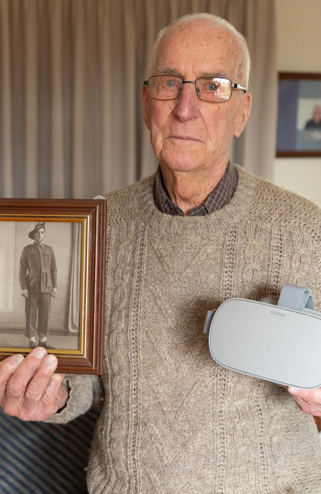 Death Railway veteran Jim Kerr with a photo of himself in uniform after watching the Anzac360 VR film of Hellfire Pass. Picture: Maxim Drygin.