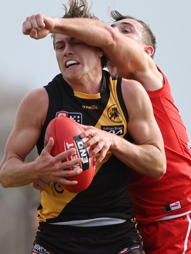 Tiger Archie Lovelock marks strongly in front of North Adelaide’s Alex Spina during Glenelg’s five-goal win at Prospect. Picture: David Mariuz/SANFL