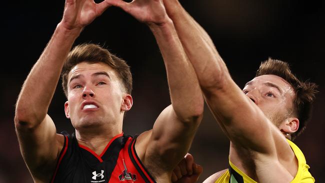 MELBOURNE . 20/08/2022. AFL. Round 23. Essendon vs Richmond at the MCG.    Richmonds Noah Balta spoils from behind Zach Reid of the Bombers during the 1st qtr.   . Picture: Michael Klein