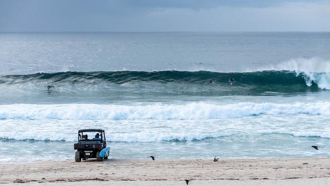 Authorities keep an eye on surfers at Bondi Beach around 7.30am on Sunday, 19 April 2020. (Image / Monique Harmer)