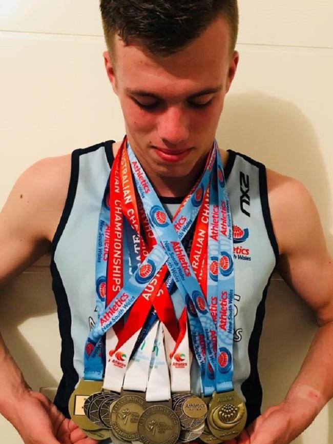 Keegan Bell with his massive medal haul.