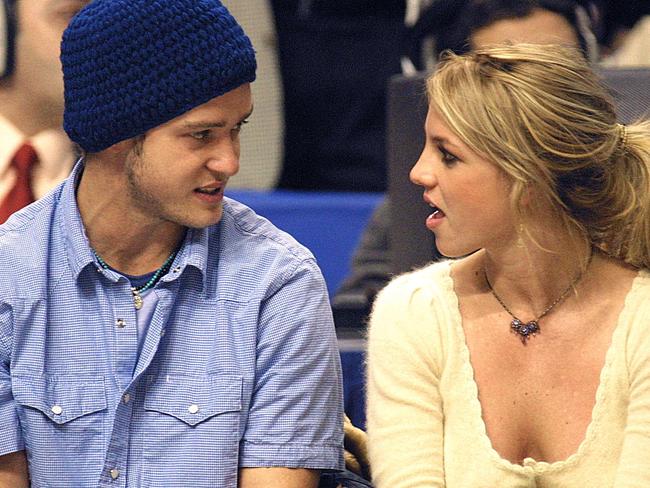 (FILES) Pop superstars Britney Spears (R) and boyfriend Justin Timberlake (L) talk as they sit courtside at the NBA All-Star Game 10 February 2002 in Philadelphia. Britney Spears says in her eagerly anticipated new memoir that she had an abortion during her relationship with Justin Timberlake over two decades ago, according to an excerpt released October 17, 2023. (Photo by TOM MIHALEK / AFP)