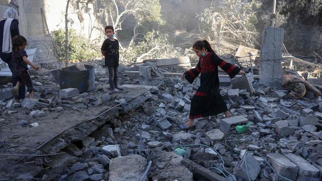 A girl walks over debris after an overnight Israeli strike in Jabalia. Picture: Bashar Taleb / AFP
