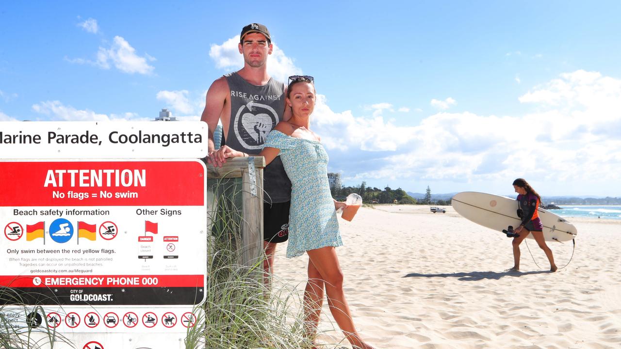 While Max Whittaker, 26, from Tweed Heads surfed yesterday, girlfriend Anna Hammond, 27, from Bilinga, was asked to leave the beach at Coolangatta. Picture: Glenn Hampson