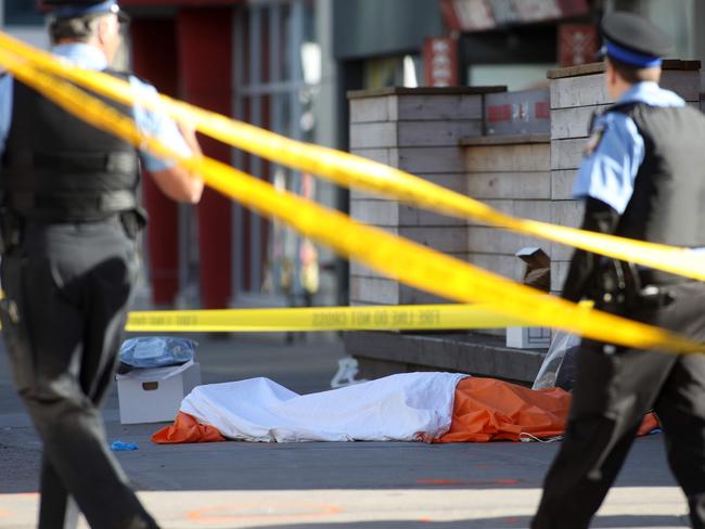 Police officers stand near one of the bodies on the street after a truck drove up on the curb and hit several pedestrians in Toronto. Picture: AFP