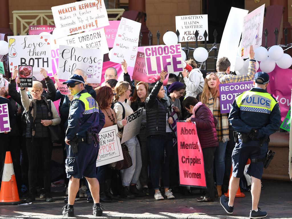 Anti-abortion advocates seen during a rally outside the New South Wales Parliament house in Sydney, Tuesday, August 6, 2019. (AAP Image/Joel Carrett)