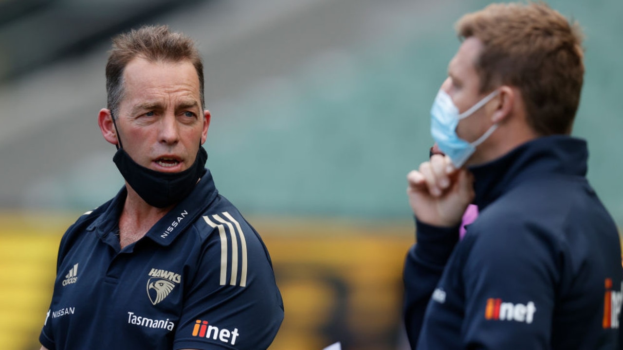 MELBOURNE, AUSTRALIA - AUGUST 21: Senior coach Alastair Clarkson and Head of Development Sam Mitchell of the Hawks share a discussion during the 2021 AFL Round 23 match between the Richmond Tigers and the Hawthorn Hawks at the Melbourne Cricket Ground on August 21, 2021 in Melbourne, Australia. (Photo by Michael Willson/AFL Photos via Getty Images)