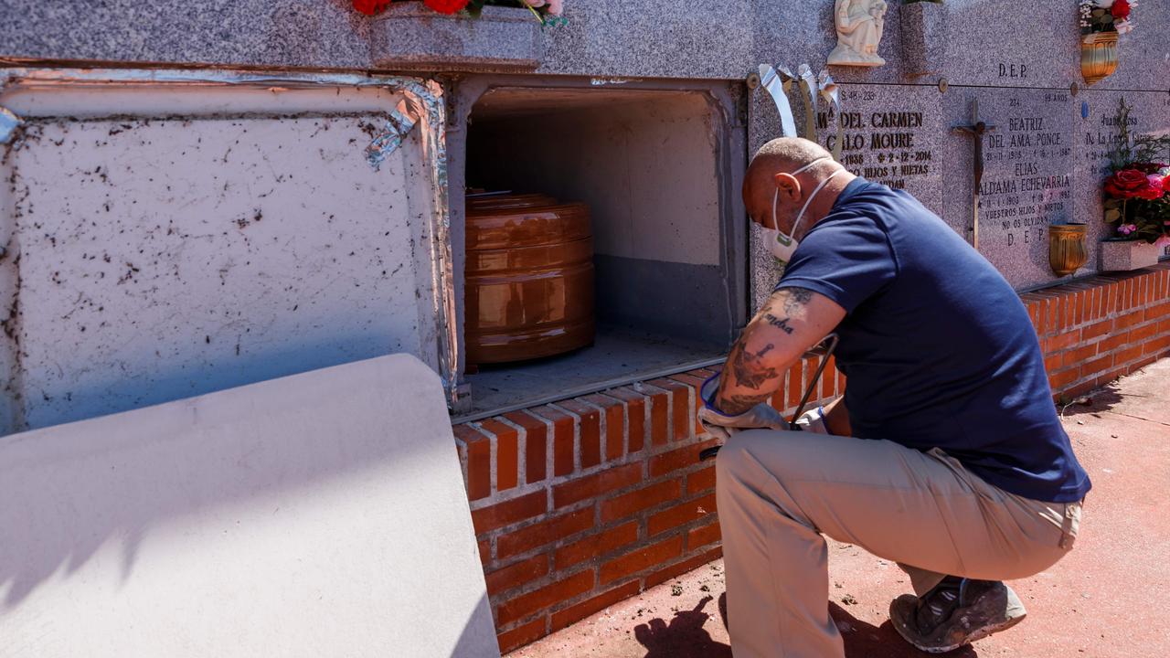 A mortuary employee wearing a face mask at the Fuencarral cemetery in Madrid on March 29, 2020. Picture: Baldesca Samper/AFP