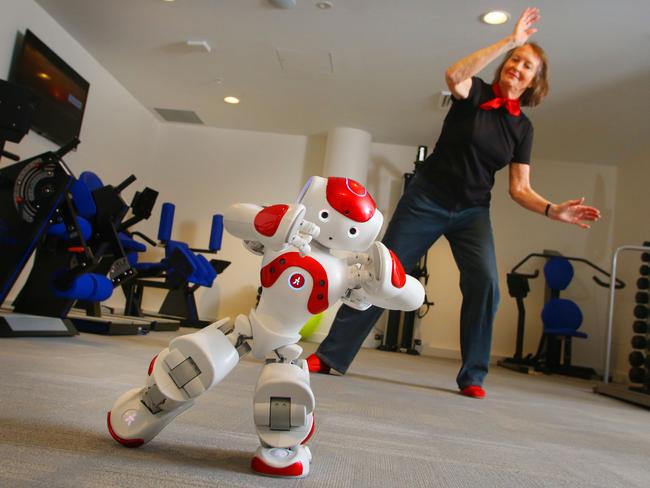 A resident does tai chi with a robot in the gym at Mark Moran Vaucluse.